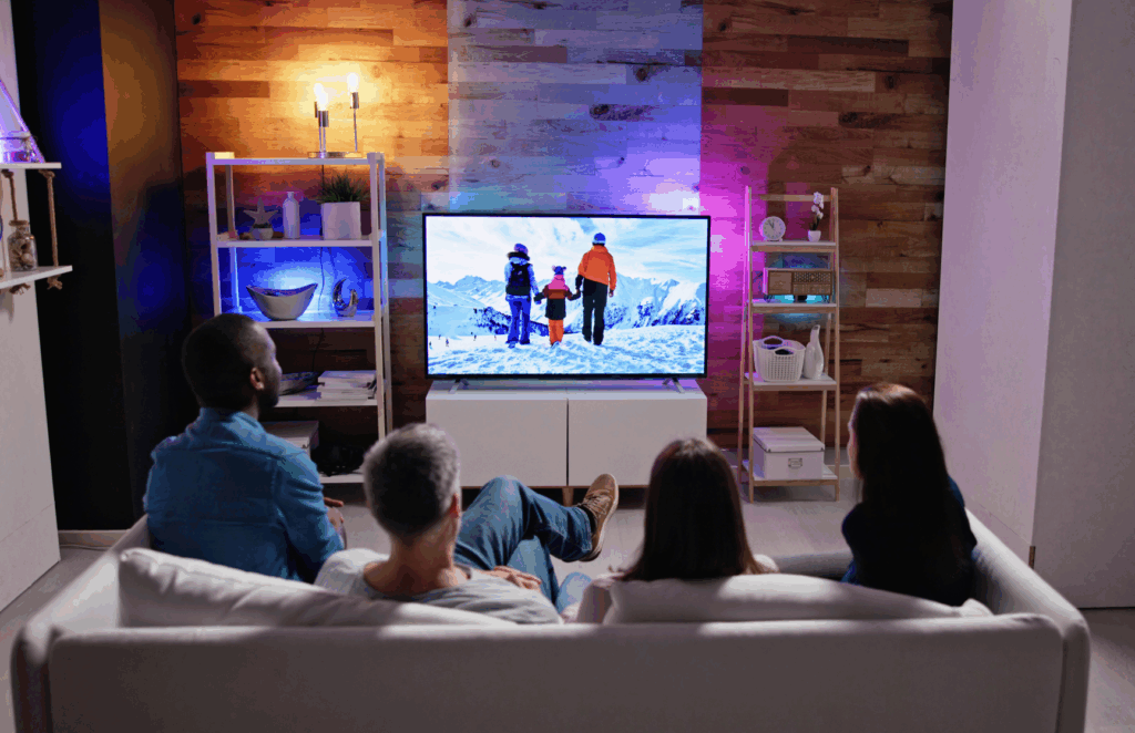 Group of people watching television together in a living room