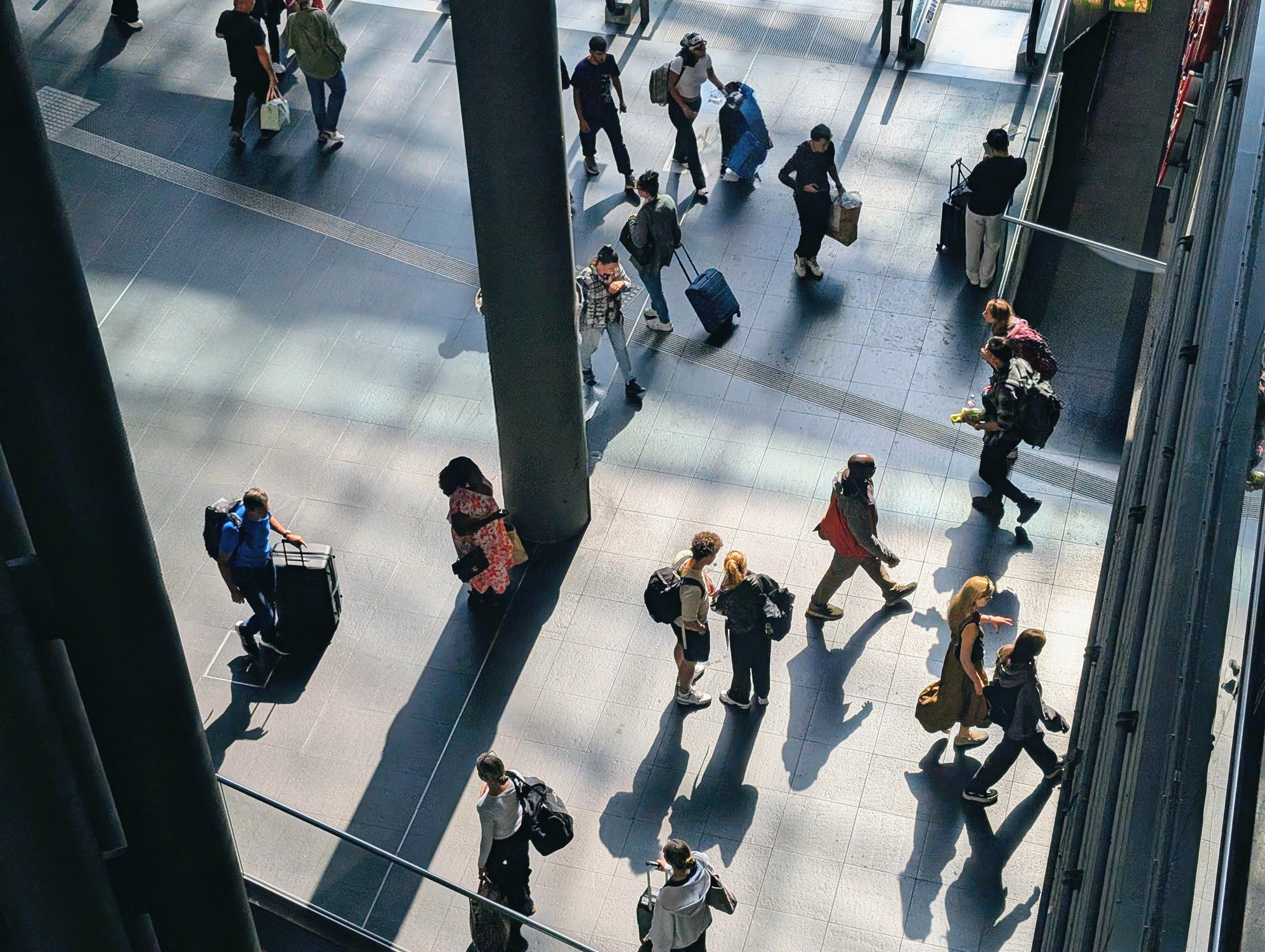 People walking through a busy travel terminal
