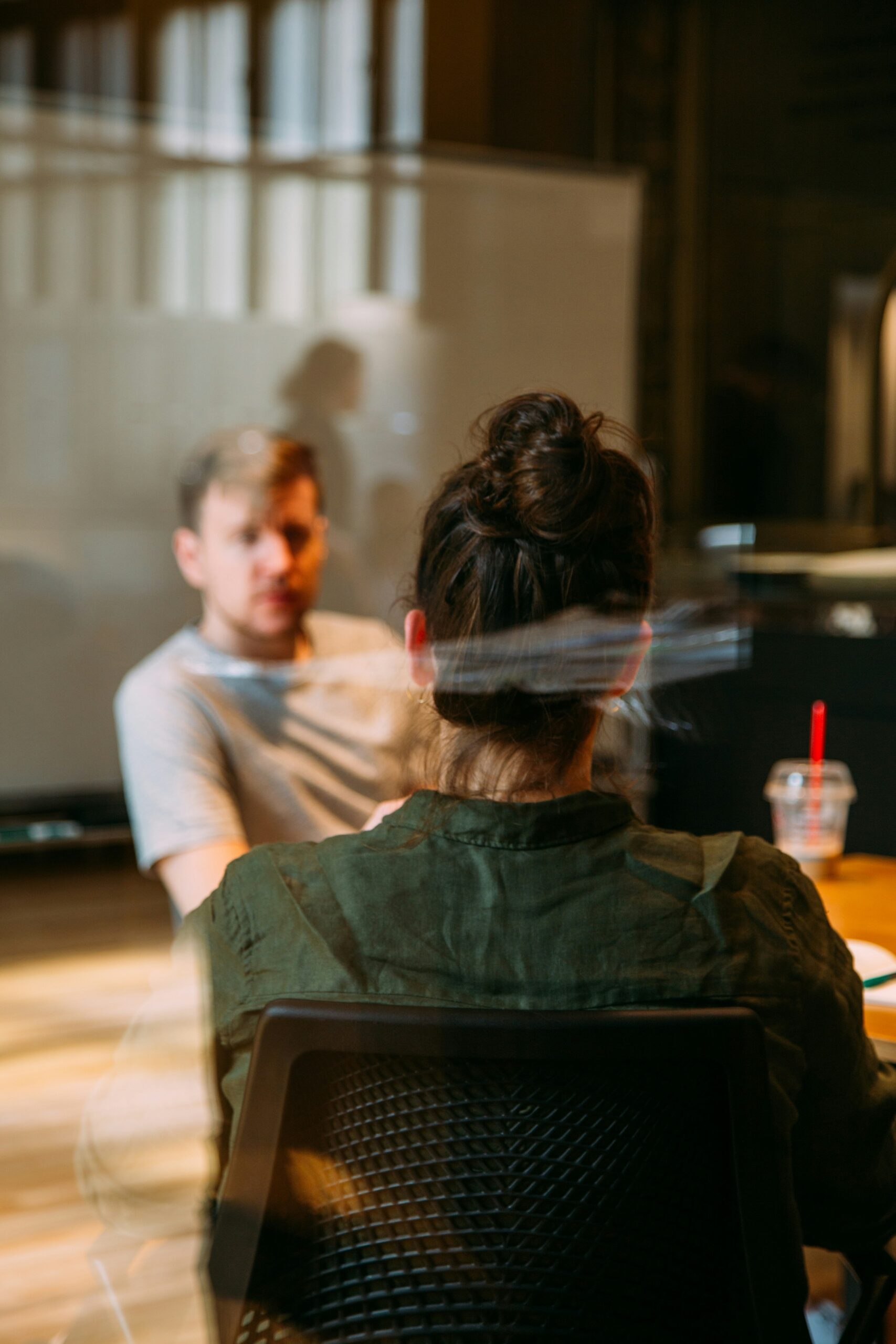 Two colleagues in discussion during a meeting