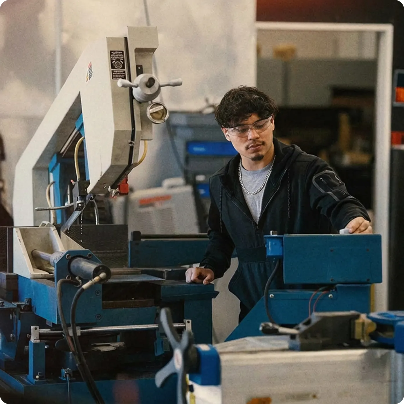 Technician operating industrial manufacturing equipment